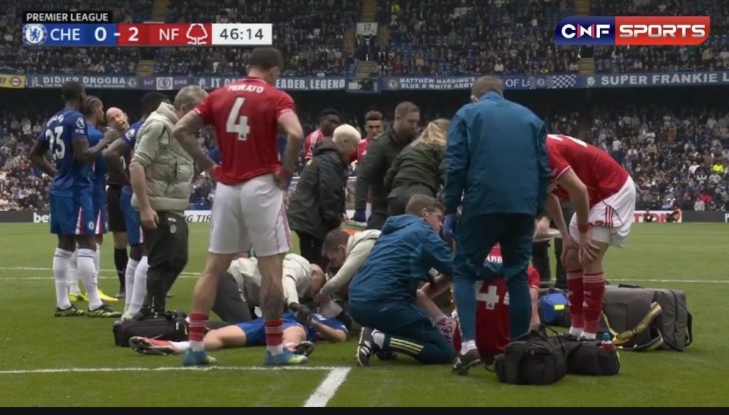 Jesse-Derry-is-treated-on-the-pitch-at-Stamford-Bridge.jpg