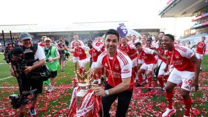 london-england-mikel-arteta-manager-of-arsenal-celebrates-with-the-premier-league-trophy-as_munjjxwx.jpeg
