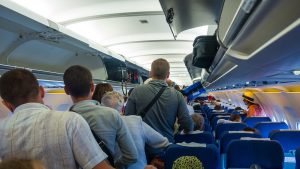 passengers-stand-trying-to-get-off-plane.jpg